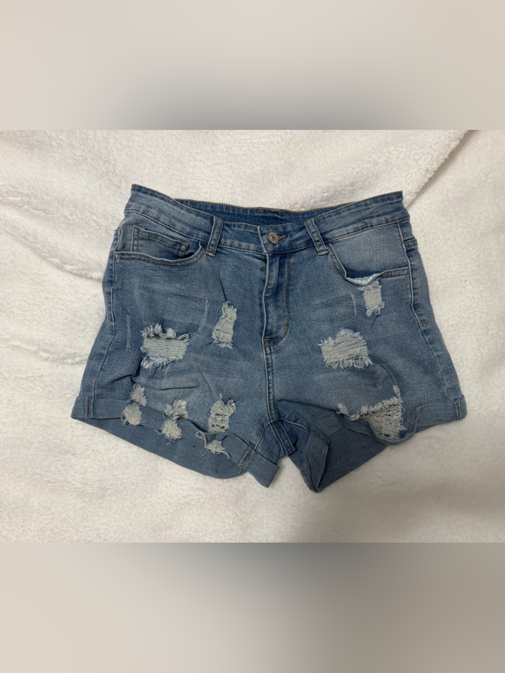 High-Rise Distressed Denim Shorts in Blue